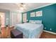 Spacious bedroom with hardwood floors and teal accent wall at 5513 N Peachtree Rd, Dunwoody, GA 30338