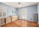 Bedroom with hardwood floors, neutral walls, and two dressers at 5513 N Peachtree Rd, Dunwoody, GA 30338