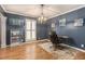 Formal dining room with dark walls, chandelier, and hardwood floors at 5513 N Peachtree Rd, Dunwoody, GA 30338