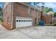 Two-car garage with attached carport and ample driveway space at 5513 N Peachtree Rd, Dunwoody, GA 30338