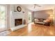 Gathering room with a white brick fireplace and hardwood floors at 5513 N Peachtree Rd, Dunwoody, GA 30338
