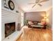 Living room with hardwood floors, a fireplace and neutral wall colors at 5513 N Peachtree Rd, Dunwoody, GA 30338