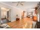 Open living room features hardwood floors, a fireplace, and access to kitchen at 5513 N Peachtree Rd, Dunwoody, GA 30338