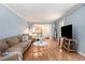 Living room with hardwood floors, large TV, and comfy seating at 5513 N Peachtree Rd, Dunwoody, GA 30338