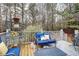 Wooden deck with blue furniture and tranquil wooded backdrop at 8919 Elina Rose, Douglasville, GA 30134