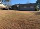 Large backyard with covered patio and mature trees at 100 Glace Rd, Atlanta, GA 30349