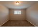 Well-lit bedroom with neutral walls and carpet at 100 Glace Rd, Atlanta, GA 30349