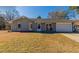 Newly renovated ranch home with gray brick exterior and a 1-car garage at 100 Glace Rd, Atlanta, GA 30349