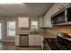 Modern kitchen with stainless steel appliances and granite counters at 100 Glace Rd, Atlanta, GA 30349