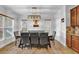 Bright dining room with a large table and gray chairs, hardwood floors at 2173 Misty Brook Ct, Buford, GA 30519