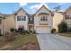 Two-story house with beige siding, a three-car garage, and a well-maintained lawn at 2173 Misty Brook Ct, Buford, GA 30519