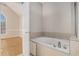 Bathroom with garden tub and access to bedroom at 3542 Linecrest Rd, Ellenwood, GA 30294