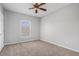 Spacious bedroom with carpeted floor, ceiling fan, and window at 3542 Linecrest Rd, Ellenwood, GA 30294