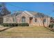 Brick ranch house with a landscaped lawn and mature trees at 3542 Linecrest Rd, Ellenwood, GA 30294