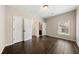 Simple bedroom with dark hardwood floors and white doors at 6235 Stillwood Ln, Cumming, GA 30041