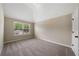 Bright bedroom with a window and grey carpet at 6235 Stillwood Ln, Cumming, GA 30041