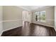 Formal dining room with large window and hardwood floors at 6235 Stillwood Ln, Cumming, GA 30041