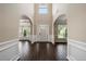 Two-story foyer with dark hardwood floors and white wainscoting at 6235 Stillwood Ln, Cumming, GA 30041