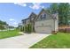 House exterior showcasing landscaping and driveway at 6235 Stillwood Ln, Cumming, GA 30041