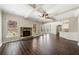 Open living space with hardwood floors and a stone fireplace at 6235 Stillwood Ln, Cumming, GA 30041