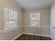 Simple bedroom with hardwood floors and two windows at 2884 Santa Monica Dr, Decatur, GA 30032