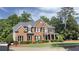 Two-story brick home with a large front yard and mature trees at 2968 Winterthur Close Nw, Kennesaw, GA 30144