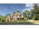 A traditional brick home with a manicured lawn and mature landscaping in a suburban neighborhood at 2968 Winterthur Close Nw, Kennesaw, GA 30144