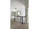 A carpeted hallway featuring white railings and trim on the stairway at 2968 Winterthur Close Nw, Kennesaw, GA 30144
