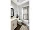 Updated powder room with a white vanity and neutral decor at 2968 Winterthur Close Nw, Kennesaw, GA 30144