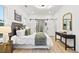 Spacious bedroom with a plush bed and sliding barn doors leading to the bathroom at 4217 Danforth Sw Rd, Atlanta, GA 30331