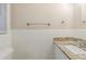 Simple bathroom with white tiled walls and granite countertop at 3701 Glen Mora Dr, Decatur, GA 30032
