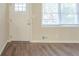 Front entry with white door, wood-look flooring, and window with blinds at 3701 Glen Mora Dr, Decatur, GA 30032