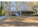 Ranch style home with gray brick exterior, attached carport, and landscaped lawn at 3701 Glen Mora Dr, Decatur, GA 30032