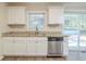 Kitchen with white cabinets, granite countertops, and stainless steel dishwasher at 3701 Glen Mora Dr, Decatur, GA 30032