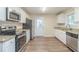 Updated kitchen featuring white cabinets, granite countertops, and stainless steel appliances at 3701 Glen Mora Dr, Decatur, GA 30032