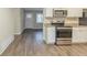 Modern kitchen with white cabinets, granite counters, and stainless steel appliances at 3701 Glen Mora Dr, Decatur, GA 30032