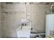 Unfinished laundry area with utility sink and shelving at 3701 Glen Mora Dr, Decatur, GA 30032