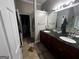 Double vanity bathroom with dark countertop and tile floor at 3971 S River Ln, Ellenwood, GA 30294