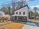 Modern two-story house with gray and white siding, a light green door, and a stone path at 665 Ferris Sw St, Atlanta, GA 30310