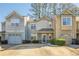 Tan and gray townhome with two-car garage and landscaped front at 3284 Long Iron Pl, Lawrenceville, GA 30044