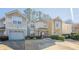 Two-story townhome with attached garage and landscaping at 3284 Long Iron Pl, Lawrenceville, GA 30044
