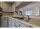 Kitchen sink and cabinets with pass through window at 3284 Long Iron Pl, Lawrenceville, GA 30044