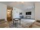 Living room with kitchen pass-through and comfy seating at 3284 Long Iron Pl, Lawrenceville, GA 30044