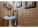 Chic powder room with pedestal sink and decorative wallpaper at 3284 Long Iron Pl, Lawrenceville, GA 30044