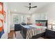 Bright bedroom with a double bed, dresser, and hardwood floors at 566 Church Ne St, Marietta, GA 30060