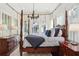 Spacious bedroom with four-poster bed and rich wood furnishings at 566 Church Ne St, Marietta, GA 30060