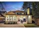 Stunning house exterior at dusk, featuring a charming patio and landscaping at 566 Church Ne St, Marietta, GA 30060