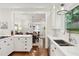 Bright kitchen features white cabinets, marble countertops, and open dining area at 566 Church Ne St, Marietta, GA 30060