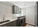 Laundry room with gray cabinets and patterned tile at 566 Church Ne St, Marietta, GA 30060