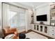 Bright living room featuring built-in shelving and a large TV at 566 Church Ne St, Marietta, GA 30060